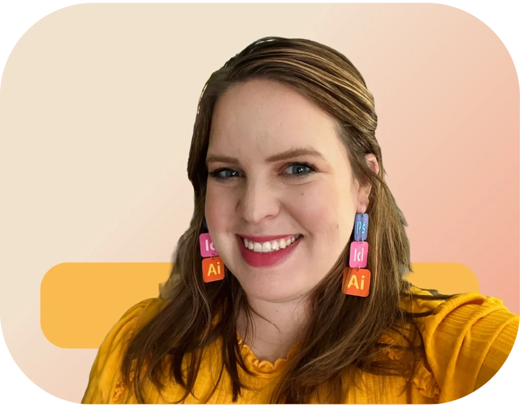 Headshot of Lindsey Engelhardt smiling. Her dark blonde hair is half up, half down. She wears a bright yellow shirt and has long dangly earrings that are the app icons for Photoshop, InDesign, and Illustrator.